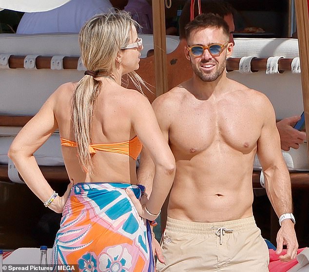 The Irish presenter displayed her toned body in an orange bikini and floral print sarong