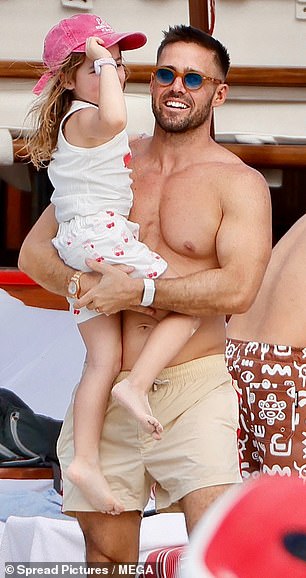 Spencer cradled his daughter as the family enjoyed another day on the Caribbean island