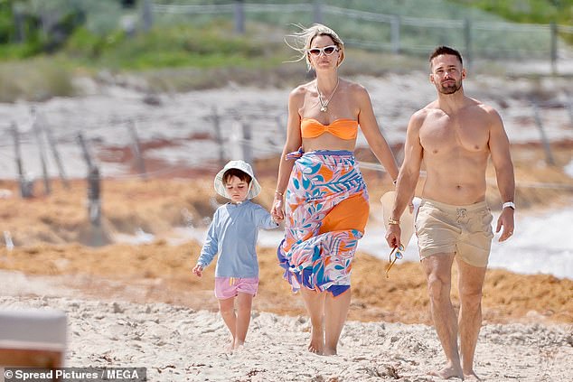 Spencer led the way as he made his way towards a bank of sunloungers with Vogue and Otto