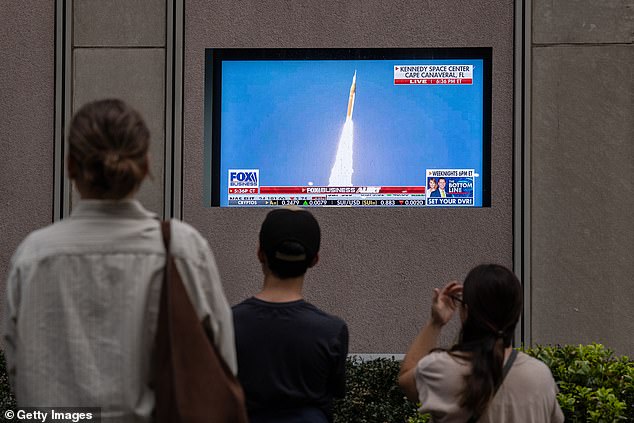 Countless Americans around the US also stopped in busy cities to view the launch on TV