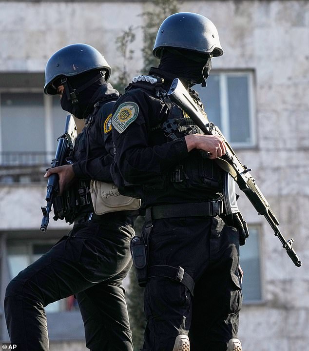 Iranian police special forces stand guard during the funeral procession. Tehran also declared that the Strait of Hormuz will remain closed to its 'enemies'