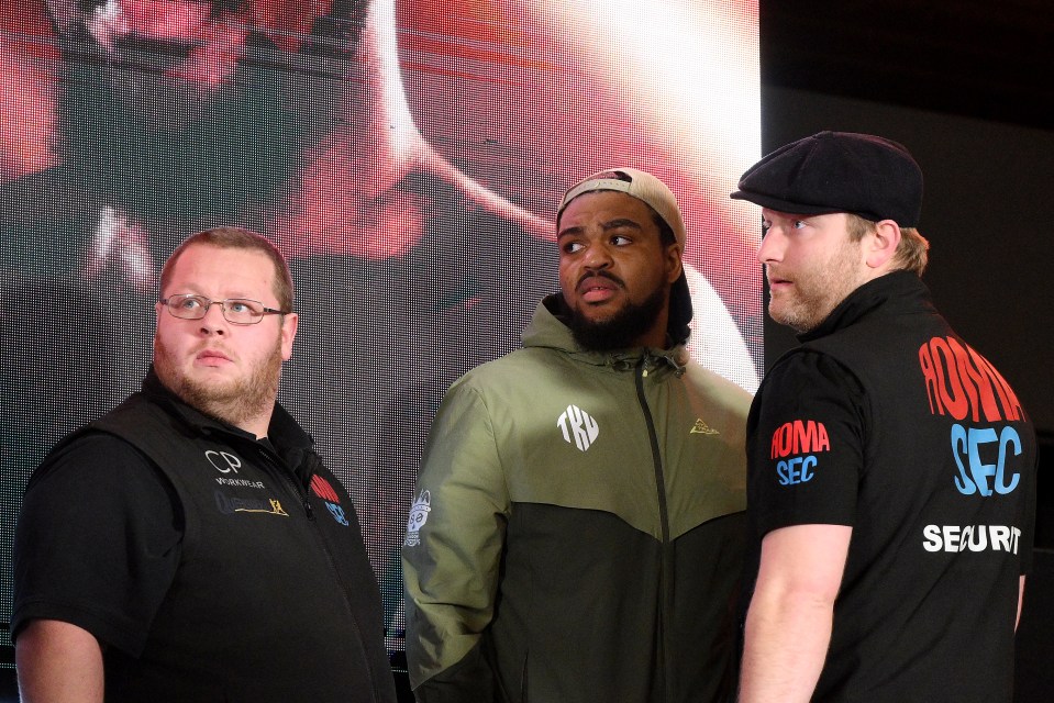 Three men at a press conference.