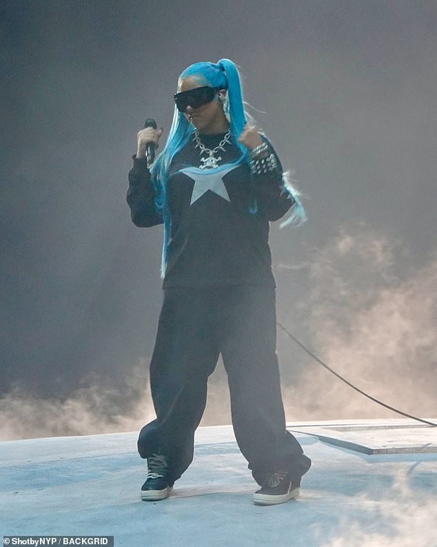 Rocking her blue hair, North gave her father a big hug in front of the gathered 70,000 fans as they performed 'Talking' and 'Piercing on My Hand'