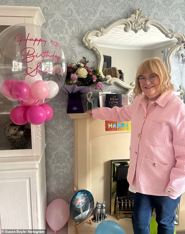 Leaning on her new mantelpiece, Susan showcased a colourful bouquet and a sea of cards congratulating her latest house move and celebrating her birthday