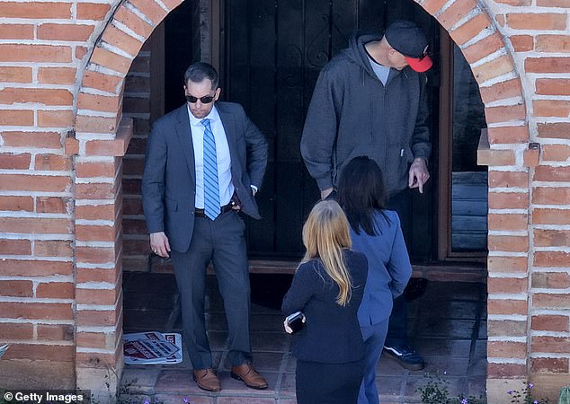 Authorities have faced dozens of questions and mounting pressure to solve the case as the investigation approaches the three-month mark. Officials are pictured above in front of Nancy's home on February 25