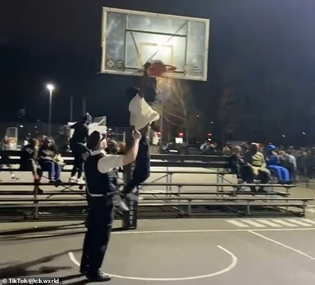 The young man runs towards PC Kyriacou, picks up the ball and performs a 360 dunk