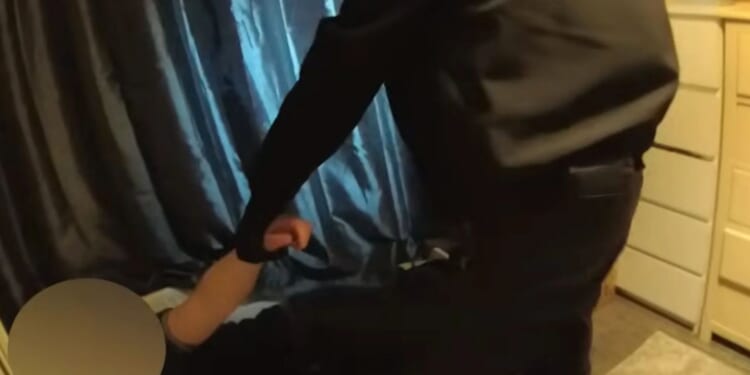 Moment dozy 'burglar' is hauled out of child's bed after falling asleep while breaking into home