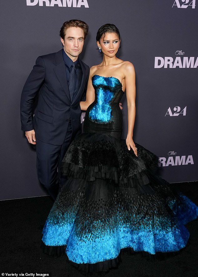 Meanwhile her co-star rocked a classic navy suit