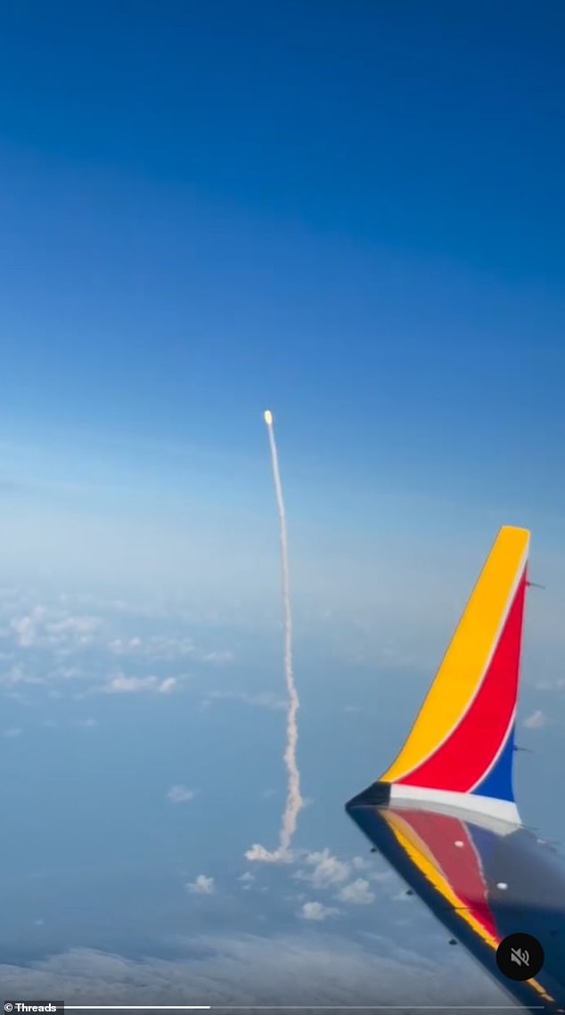 Chris Pappas' video captured the clear blue skies, with only the plane's wing in view until a line of smoke was seen trailing behind the flaming rocket in the distance