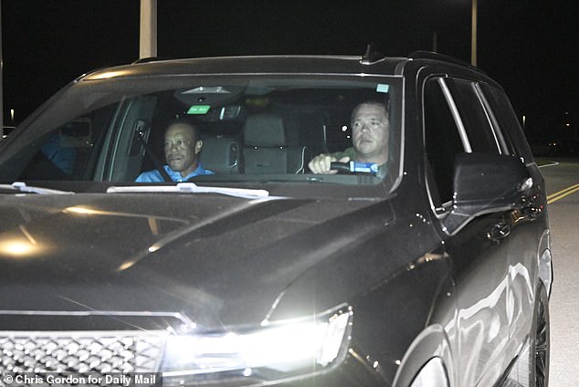 Woods is driven home from jail after being bailed out by a friend late Friday night