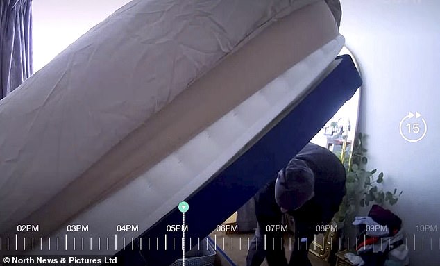 He lifts a large mattress and packs items from the bed storage area into bags