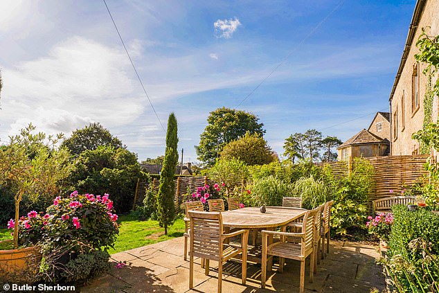 Ready for the sun: The property has a charming back garden and outdoor dining space