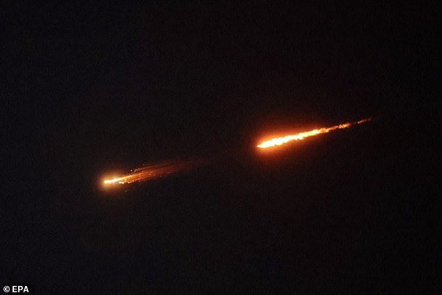 Projectiles streak across the night sky over Jerusalem on Thursday