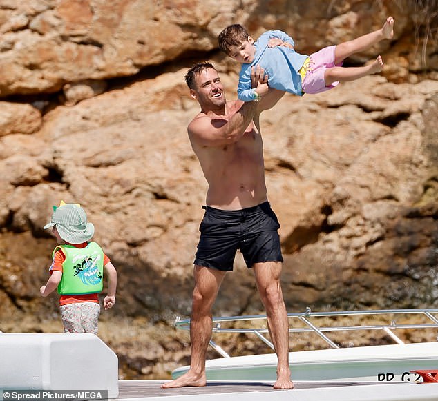 Later Spencer playfully swung son Otto high into the air