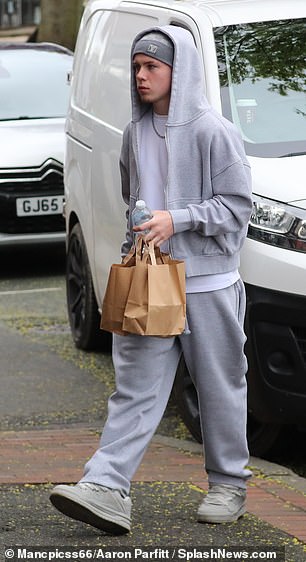 The teen was dressed in a grey tracksuit which he teamed with chunky trainers