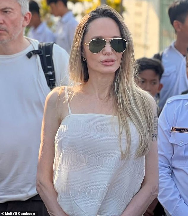 Jolie wore oversized gold-rimmed aviator sunglasses that covered most of her face