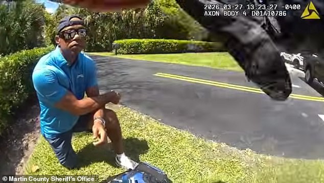 The 50-year-old kneels at the side of the road after rolling his SUV on a Jupiter Island street