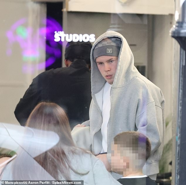 Wayne cut a casual figure as the barber got to work while Kai, 16, was seen arriving with takeaway food for the pair