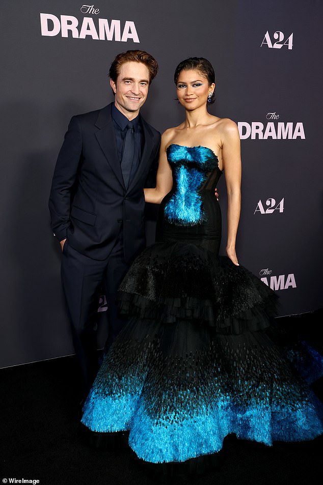 Earlier in the night, Zendaya wore her first 'something blue' outfit as she sported a strapless feathered Schiaparelli Haute Couture gown (pictured with co-star Robert Pattinson)