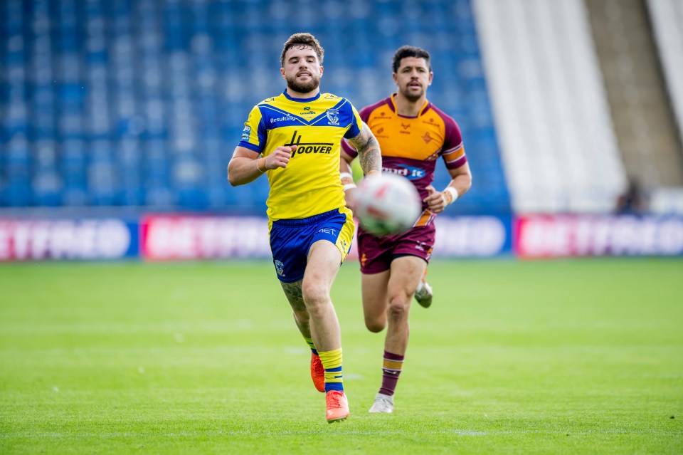 Two rugby players, one in a yellow and blue uniform and another in a maroon and gold uniform, running on a green field.