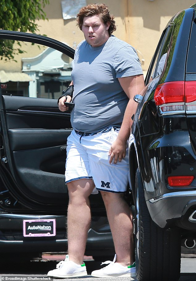 Christopher - seen in August 2018 - lost 250 pounds over the course of five years by changing his diet and focusing on a consistent exercise regime including weight lifting, boxing and hiking