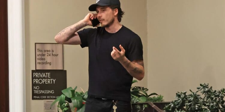 Brooklyn Beckham appears to take tense phone call during day out with wife Nicola Peltz amid ongoing family feud