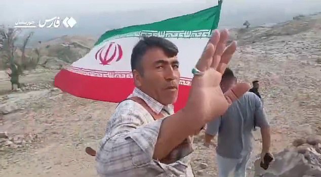 It has prompted rag-tag groups of goat herders and farmers to take up makeshift weapons and join the hunt. Pictured: Armed Iranian tribesmen search for the missing US airman