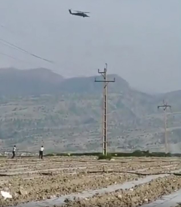 Iranian media has broadcast images of US aircraft searching for the missing airman while constantly repeating the reward for his capture. Pictured: Iranian police appearing to fire at two US helicopters as they search for the downed crewman
