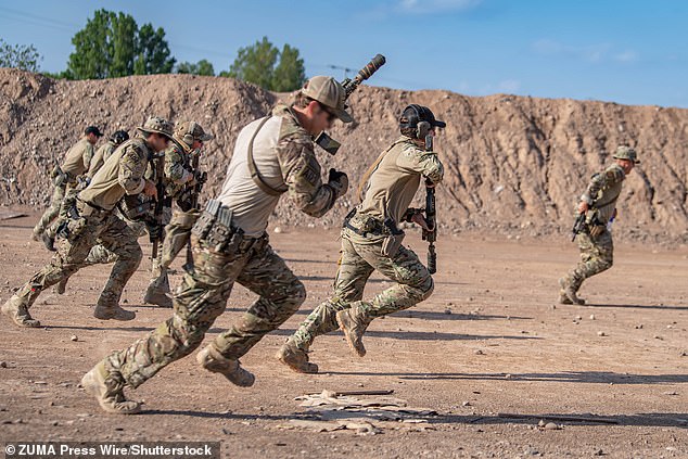 Trained to survive for several days, he will hide during daylight and if he moves at all will do so at night. Pictured: File photo of members of the US Air Force on a training exercise