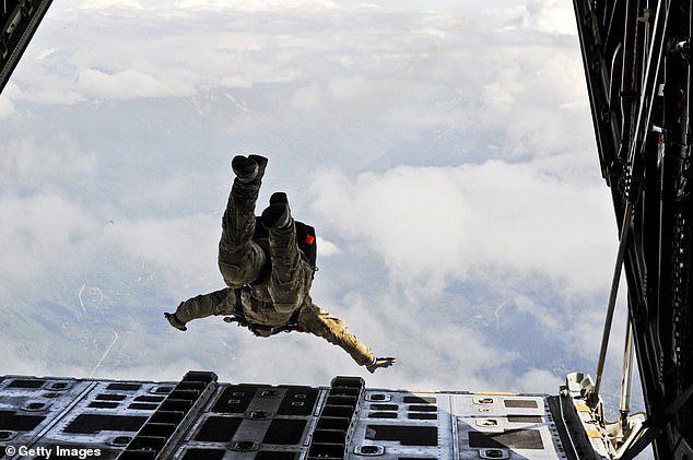The missing officer is trained in SERE (survival, evasion, resistance and escape) and may have been injured after ejecting. Pictured: File photo of a member of the US Air Force on a training exercise