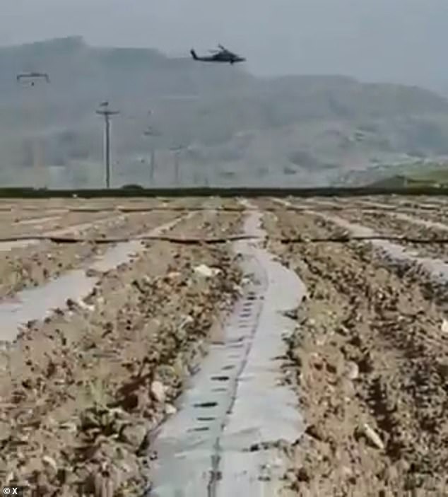 A US Black Hawk helicopter involved in the search for the missing crewman was hit by ground fire but landed safely. Pictured: Iranian police appearing to shoot at US rescue crews