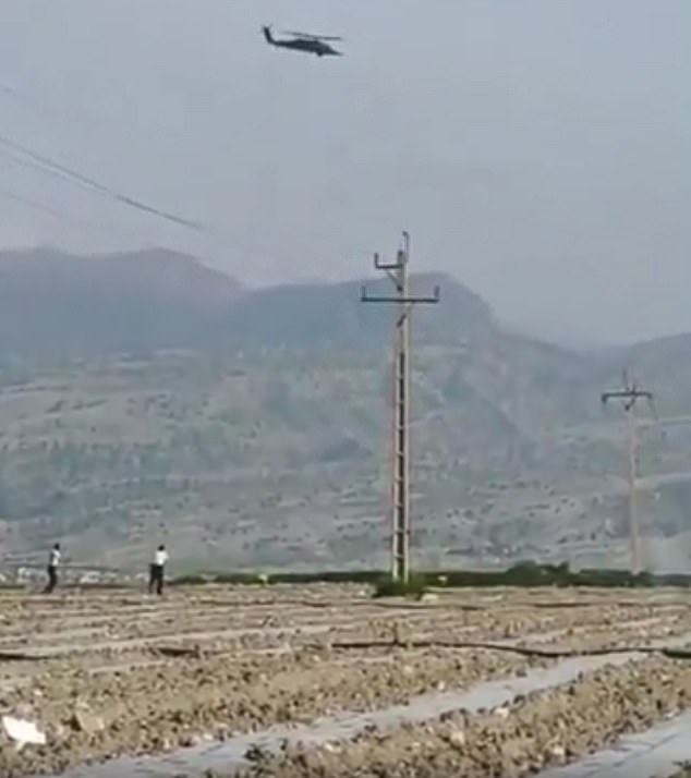 Iranians filmed the aircraft over neighbouring Khuzestan province and posted footage on social media. Pictured: Iranian police appearing to fire at two US helicopters as they searched for the downed crew
