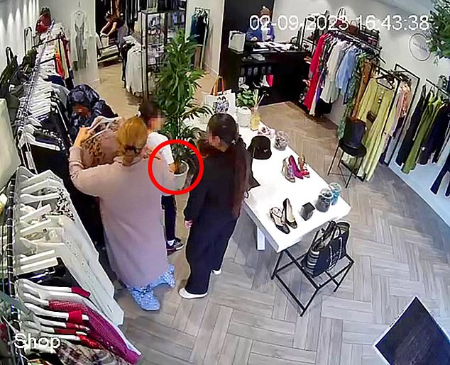 The flowery-scarf woman, in a manoeuvre that belies her sturdy frame, swoops down and the Chanel bag disappears beneath her voluminous black robes. Pictured: The spot on the floor where the bag was previously placed