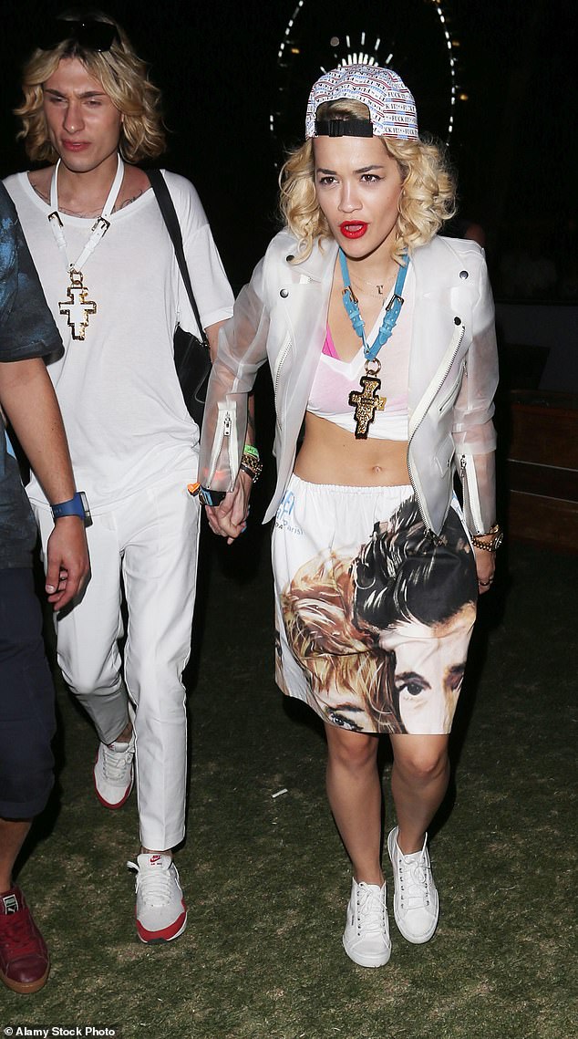 Rita Ora bared her midriff by combining a low-slung skirt and a bright pink bikini top peeking through a rolled-up white T-shirt at Coachella in 2013