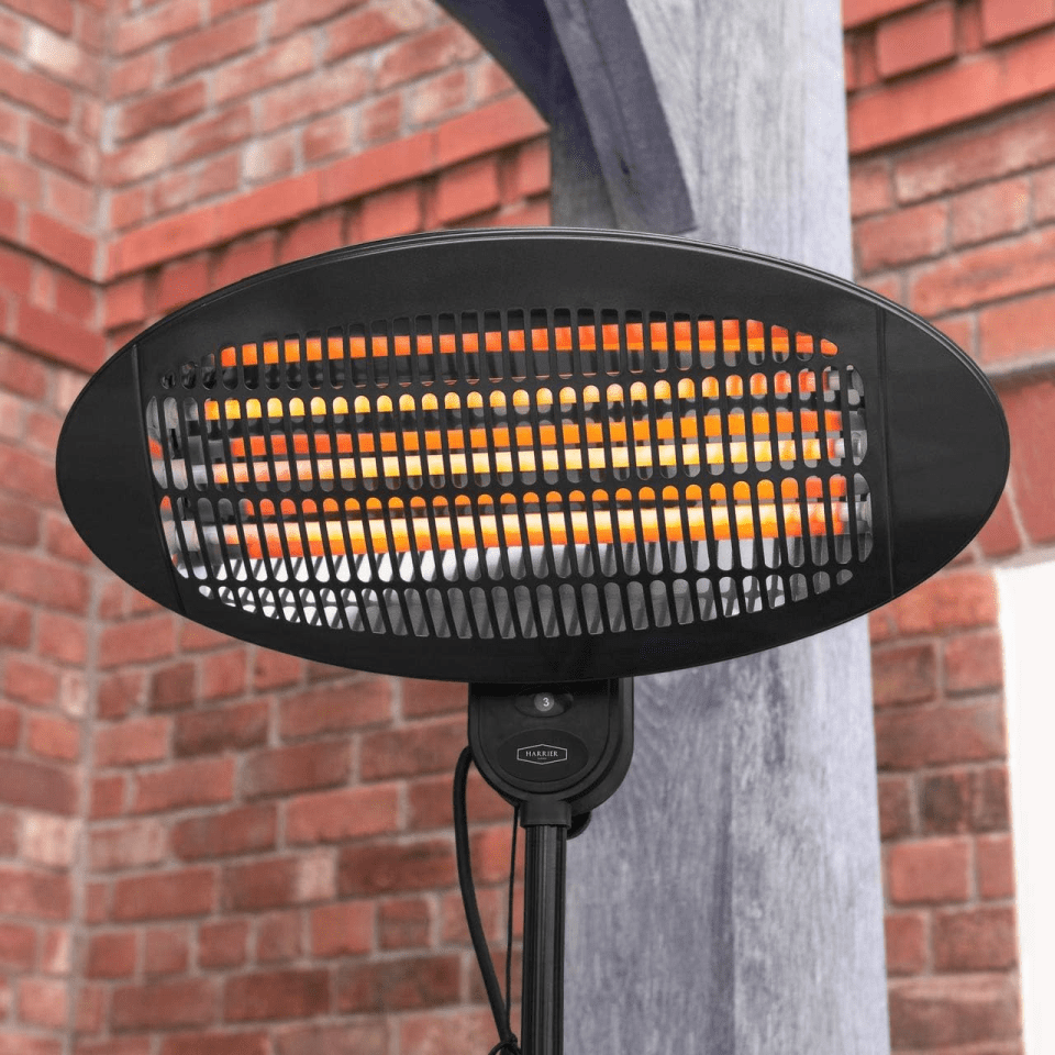 A black electric patio heater with glowing orange elements.