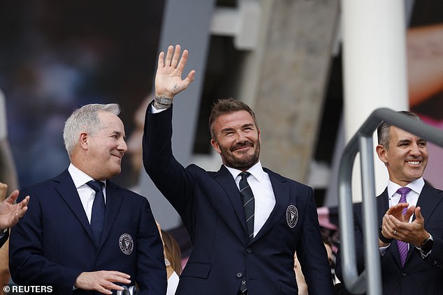 David is joined by Jorge Mas as he waves to the crowd during the stadium inauguration ceremony