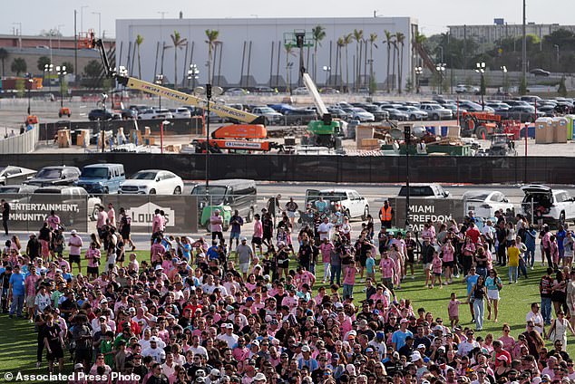 Fans wait in line to enter Nu Stadium, as signs of ongoing work are seen behind, ahead of the team's first MLS soccer match in their new stadium, against Austin FC, Saturday, April 4, 2026, in Miami. (AP Photo/Rebecca Blackwell)