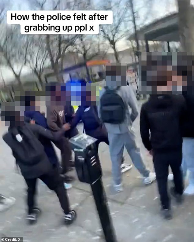 Clips show the balaclava-clad teenagers running away from officers as one cop pushed a boy who looked like he was trying to intimidate police and a girl wrestled with police