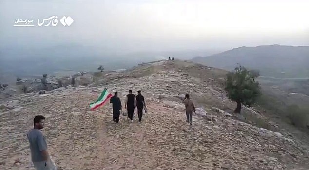 US officials had feared the missing crewman would be used as a human bargaining chip. Pictured: Armed Iranian tribesmen search for the missing US airman