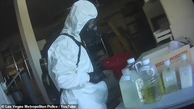 An agent clad is a hazmat suit is pictured searching the Las Vegas biolab and collecting samples for testing