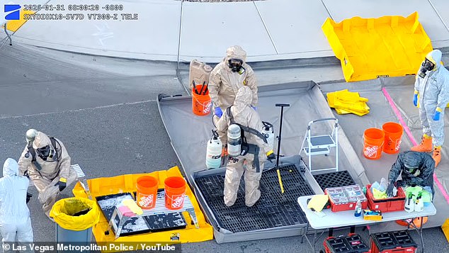 Individuals in hazmat suits are pictured standing outside the Las Vegas home after pulling samples out