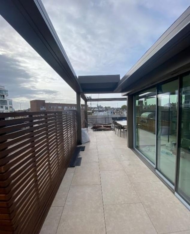 The couple said the pergola (pictured) on their home was 'visually unobtrusive, with a minimalist metal frame that complements the existing architecture'