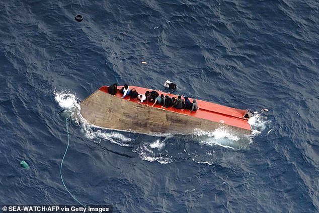 Video footage shared by Sea-Watch showed around a dozen men perched on top of the boat off the coast of Libya as others desperately try and haul themselves aboard