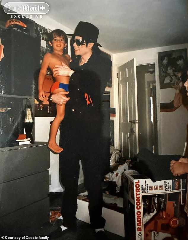 Jackson with a young Aldo Cascio at the family home in the late 1990s - one of several images now cited in a lawsuit against the singer's estate