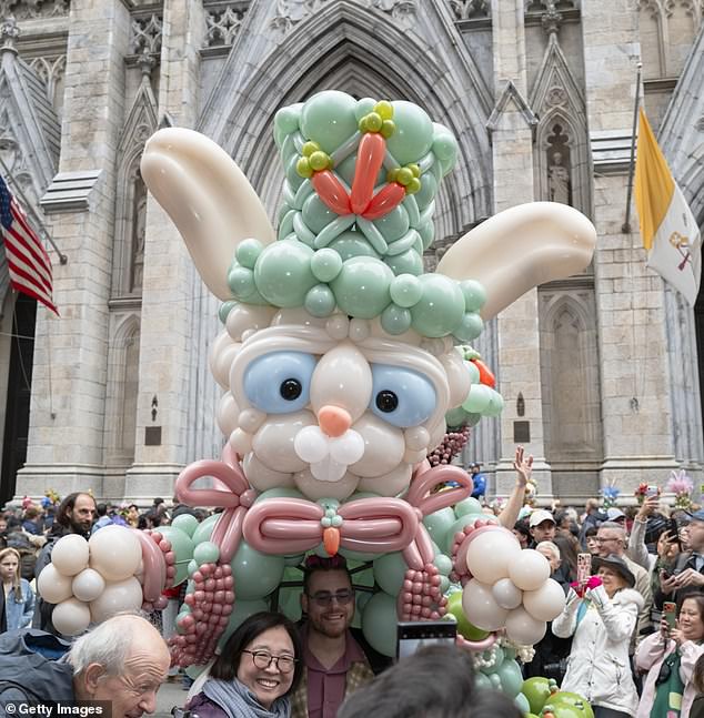 The Easter Parade crowd collected outside of St Patrick's Cathedral, while a giant balloon rabbit had event goers stopping for photos