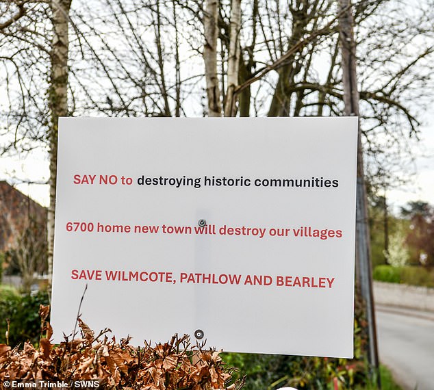 Angry residents have put up signs making their opposition to the new homes known
