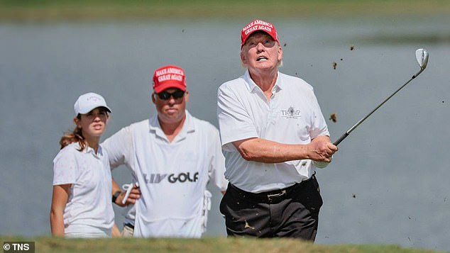 Trump plays a shot alongside his granddaughter Kai (left) in Doral, Florida