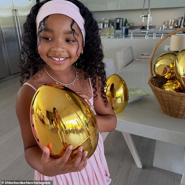 True beamed while holding an enormous golden egg