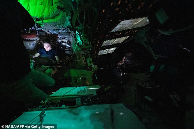 NASA astronaut Christina Koch illuminated by a screen inside the darkened Orion spacecraft. For 40 minutes of the flyby, the crew will lose contact with Earth