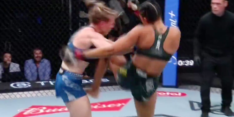 Glamorous UFC star knocked out with sickening knee to the head as quick-thinking referee dives in to save her